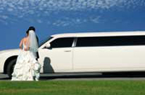 bride and groom with wedding car