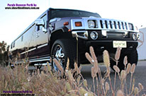 Photo of teh front grille and side of the fancy H200 Hummer Limousine in Midnight Purple